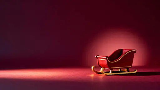 Wooden sleigh on wine-red backdrop